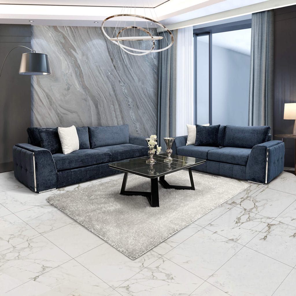 Angelino living room. Large blue sofa with white and blue cushions on it, in a luxurious living room.